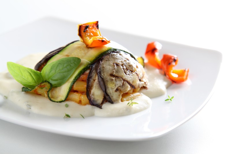 Mini timbale of baby macaroni with grilled shallot-flavoured aubergines and courgettes on a pool of cheeses